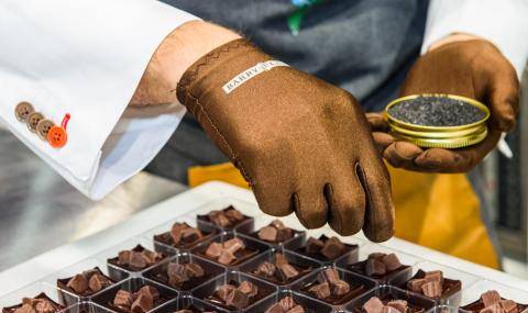 A BC Studio chef sprinkles black sea salt stop the nearly-completed bonbon cups