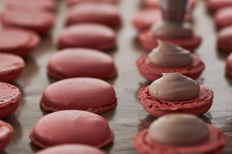 ruby macarons piped with filling